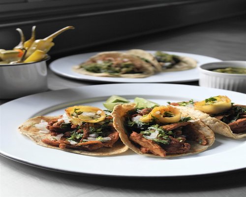 Traditional Mexican meal plate with beans, avocado, and tortillas